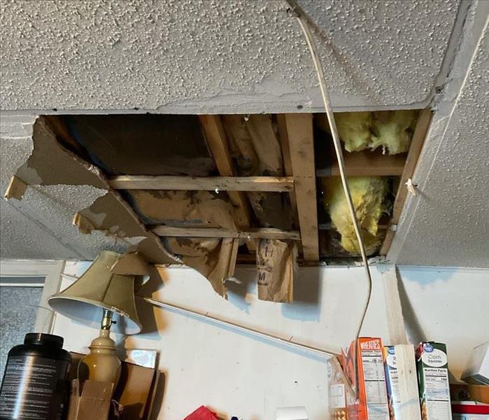 The Milford property depicted in the Before Photo experienced a basement ceiling leak that saturated and partially destroyed 