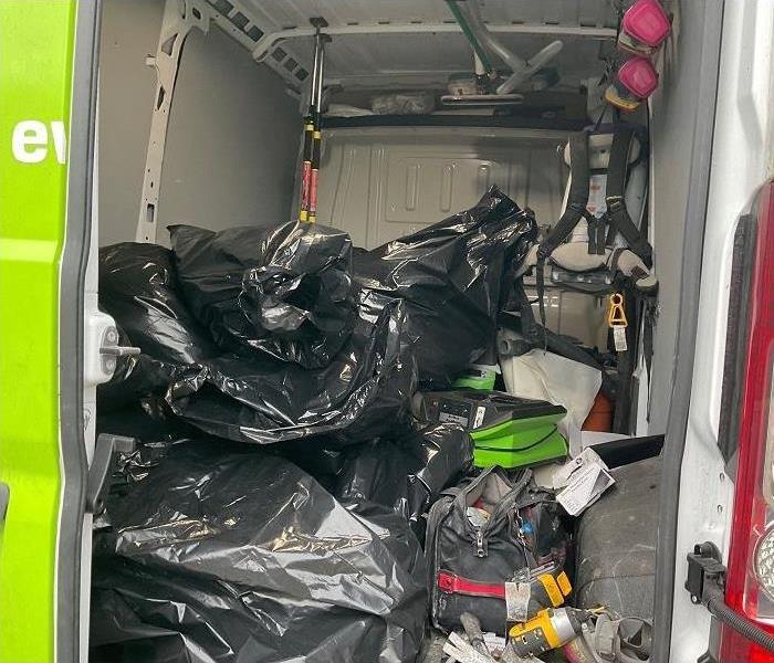 bags with damaged materials removed from home in SERVPRO vehicle