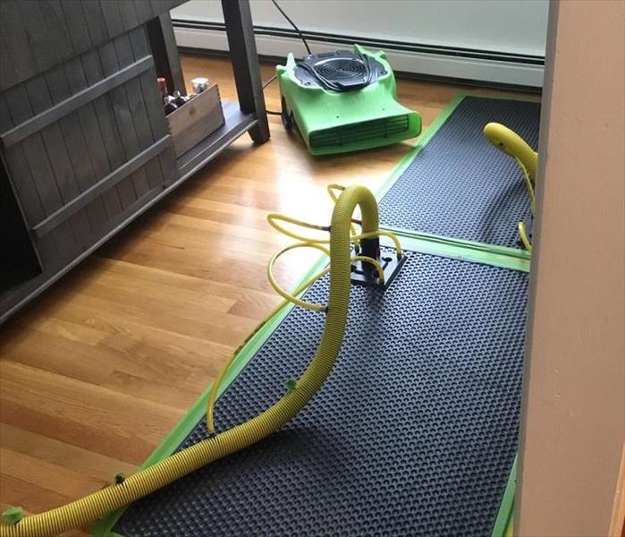 drying mat being used to dry water on hardwood floor