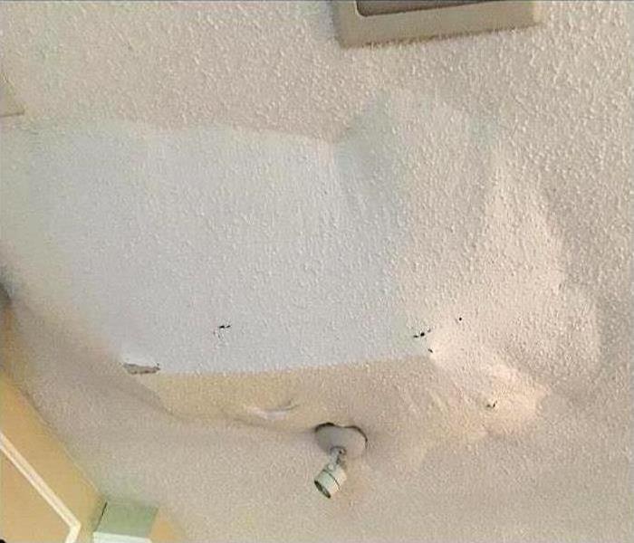 A ceiling caving in from flood damage