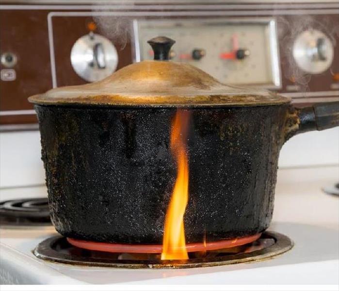 pan on stove beginning to catch on fire